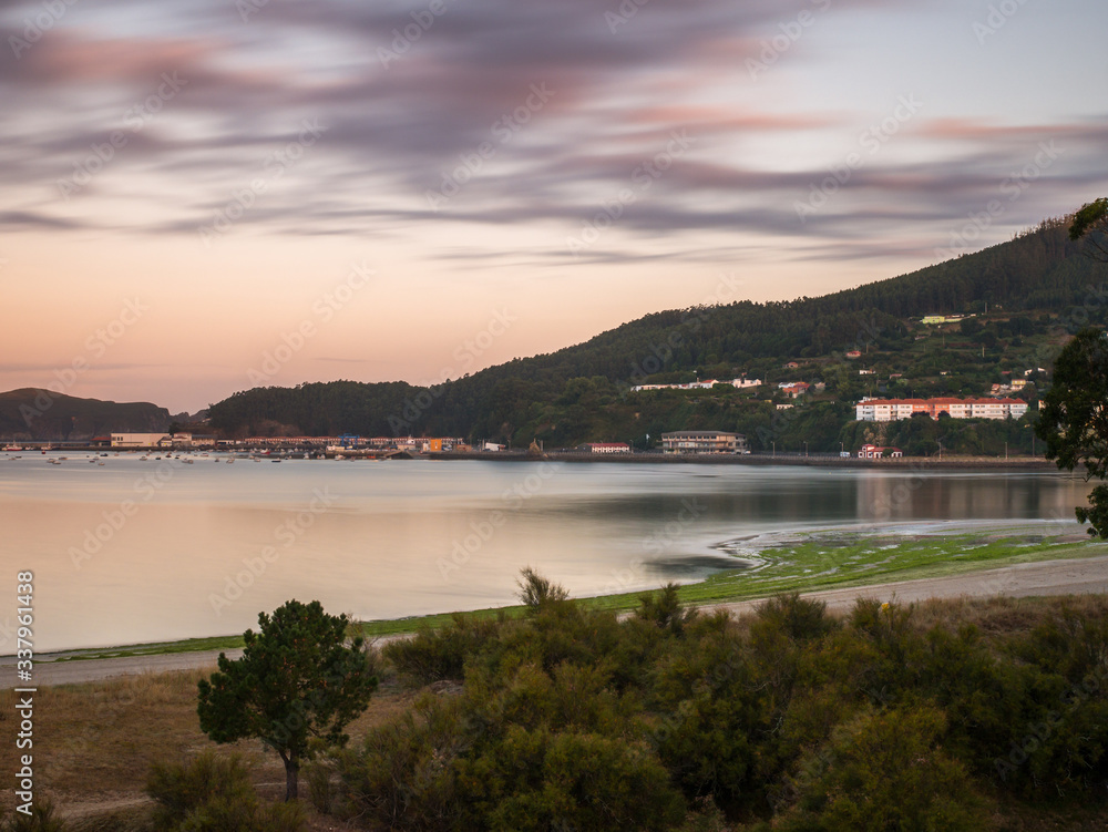View of Magdalena beach of the harbor of Cedeira at sunrise, Rias Altas, Galicia, Spain; long exposure shot