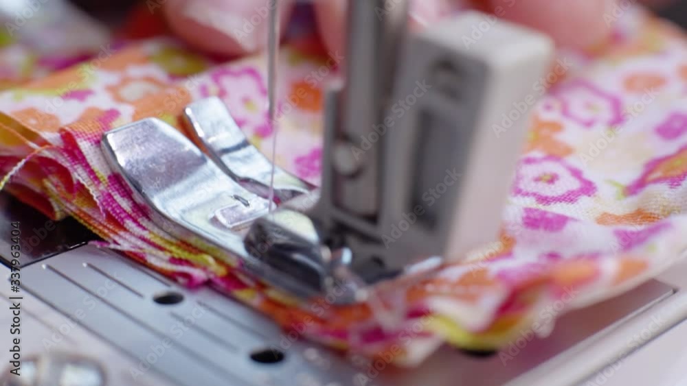 Woman sewing a face mask. Macro Woman sewing a face mask. Macro