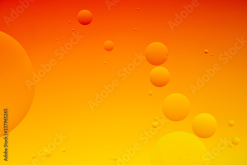 Bright abstract, yellow and orange background with flying bubbles