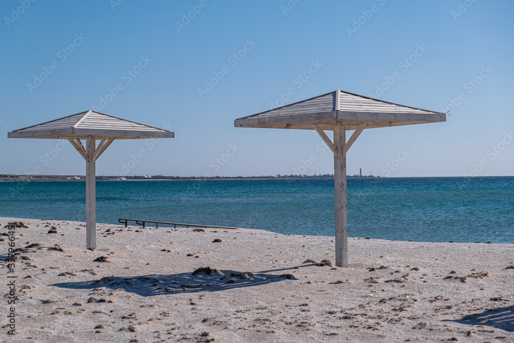 Fototapeta premium enjoying sunset under wooden canopy on beach