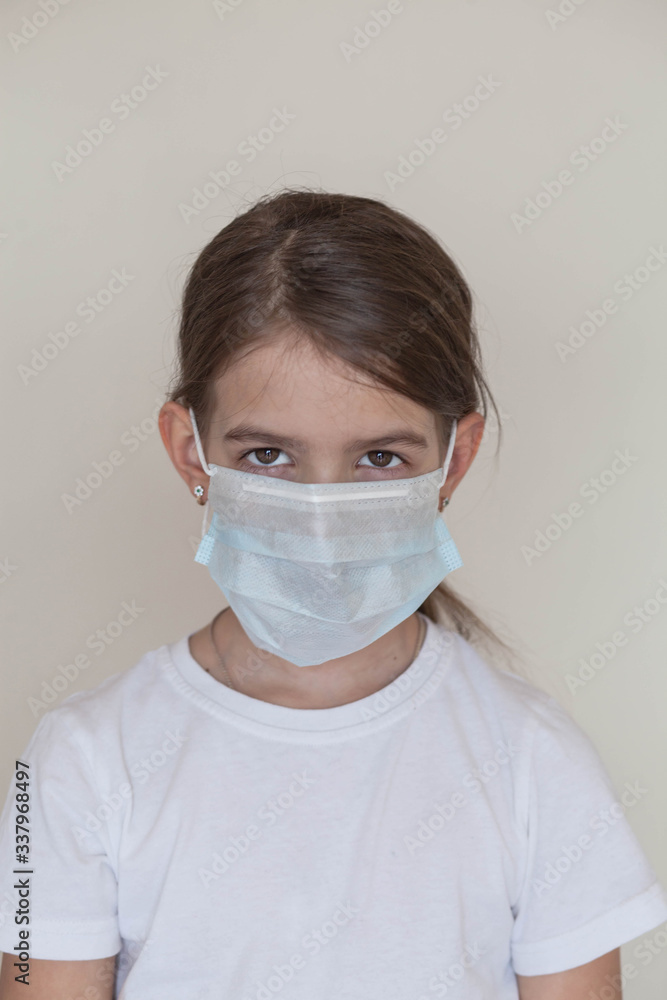 a young girl in a medical mask during the days of the coronavirus pandemic