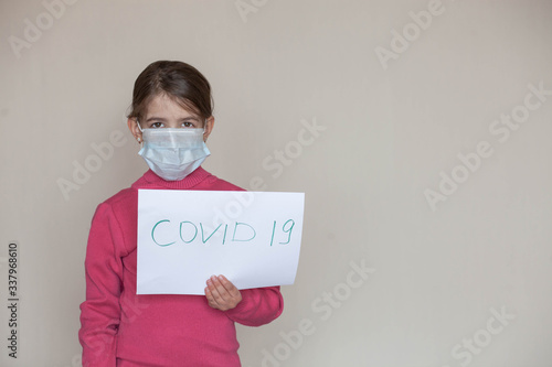 a young girl in a medical mask during the days of the coronavirus pandemic