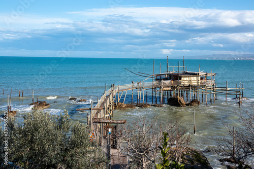 the Trabocco or trabucco (fish-trap) on the beach of Vasto, is an ancient fishing machinery on wooden pilework with long arms that support a large net, typical of Adriatic Sea. Vasto, Abruzzo,  Italy photo