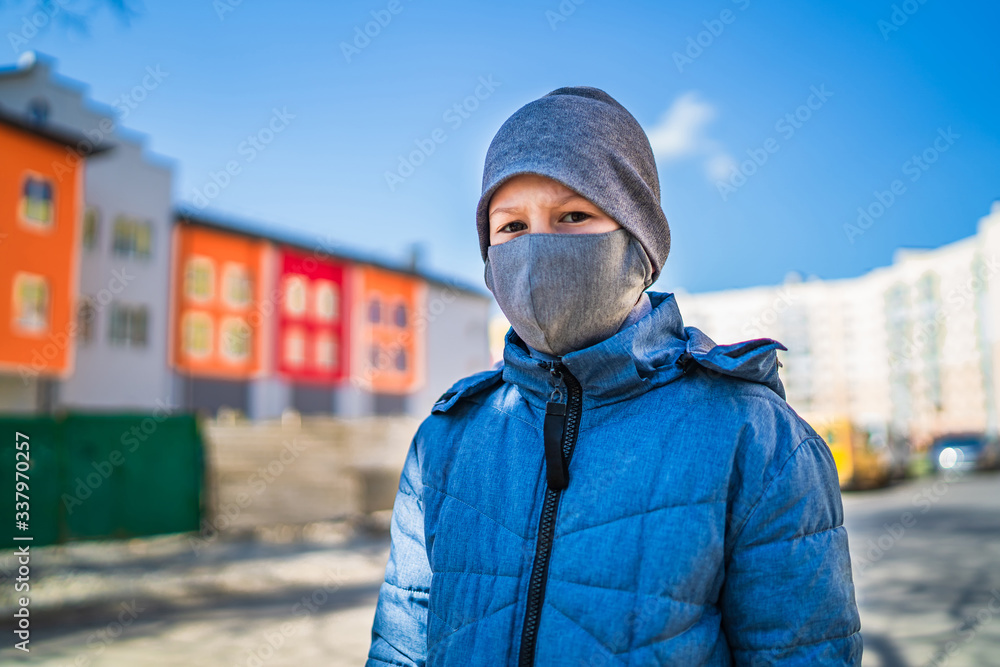 The child is wearing a protective mask and gloves. Protection against Chinese coronavirus. Care for future generations. The concept of pandemics and epidemics The child is wearing a protective mask and gloves. Protection against Chinese coronavirus. Care for future generations. The concept of pandemics and epidemics