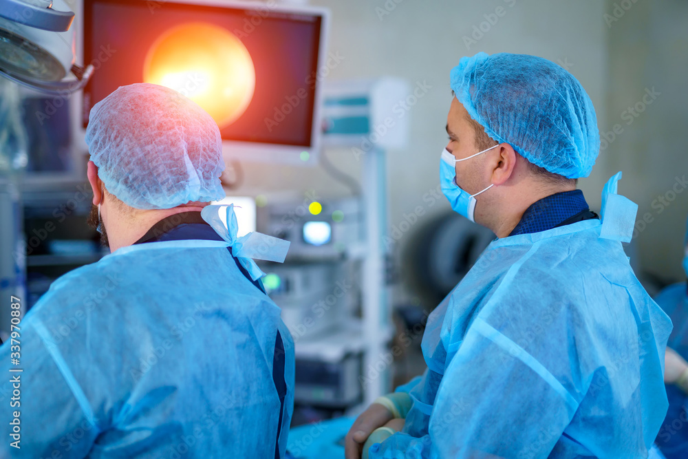 Team surgeon at work in operating room. Modern equipment in operating room. Medical devices for neurosurgery.