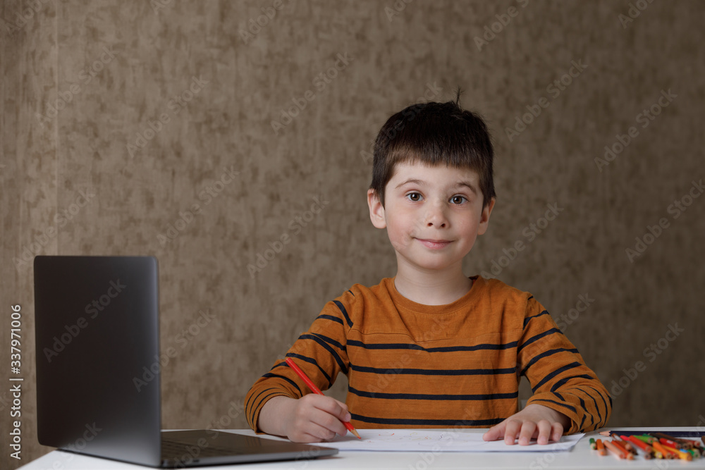 a small child is studying at the computer. Distance learning at home quarantine a small child is studying at the computer. Distance learning at home quarantine
