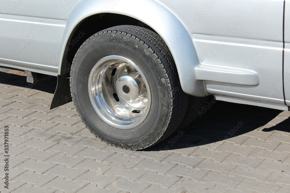 Wheel of a gray truck while stopping on a tile Wheel of a gray truck while stopping on a tile