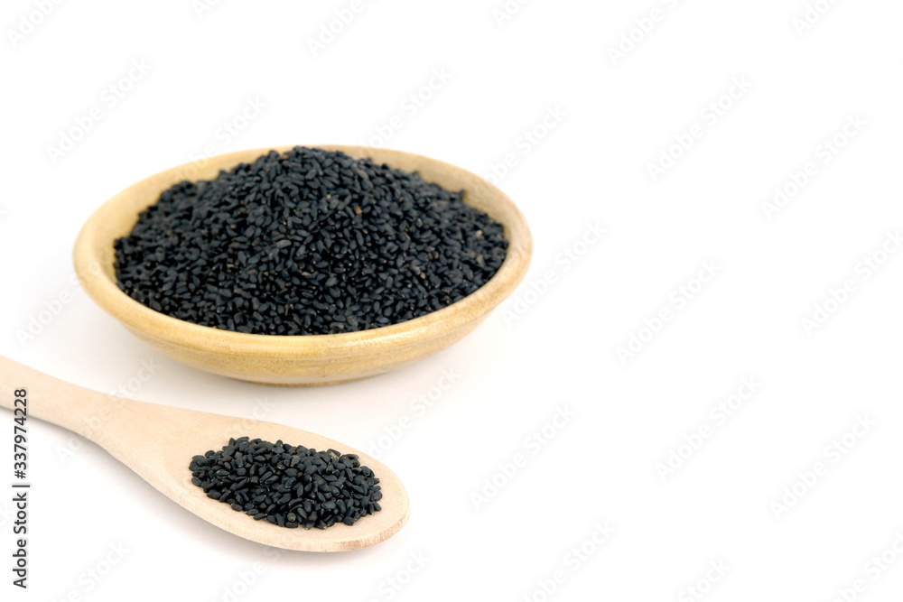 Top view sweet basil seeds on wooden bowl and spoon – isolated on white background Top view sweet basil seeds on wooden bowl and spoon – isolated on white background