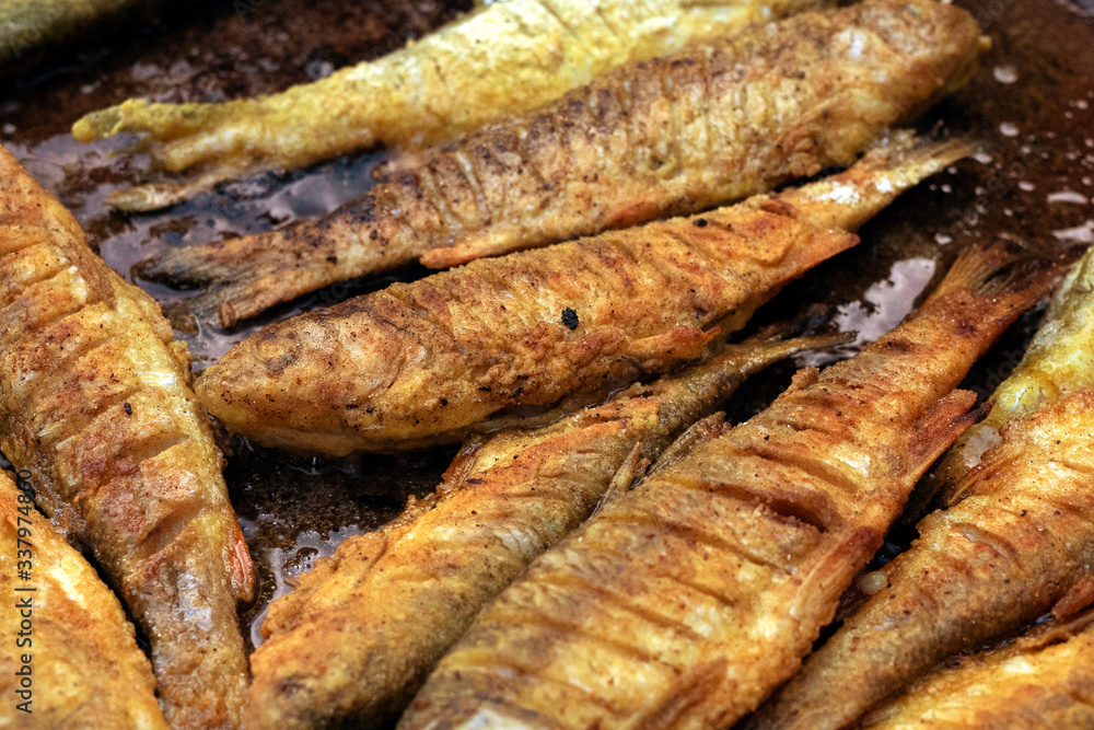 Close up grill cooked fish. rosy fried fish lies in pan. Close up grill cooked fish. rosy fried fish lies in pan.