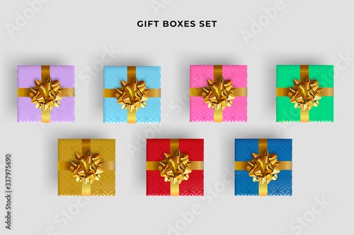 Set of colorful gift boxes with realistic gold bow. Top view.