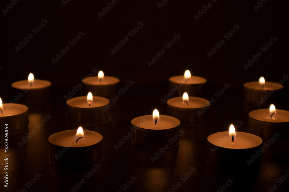 Darkness lighted up with candles burning, religious scene Darkness lighted up with candles burning, religious scene