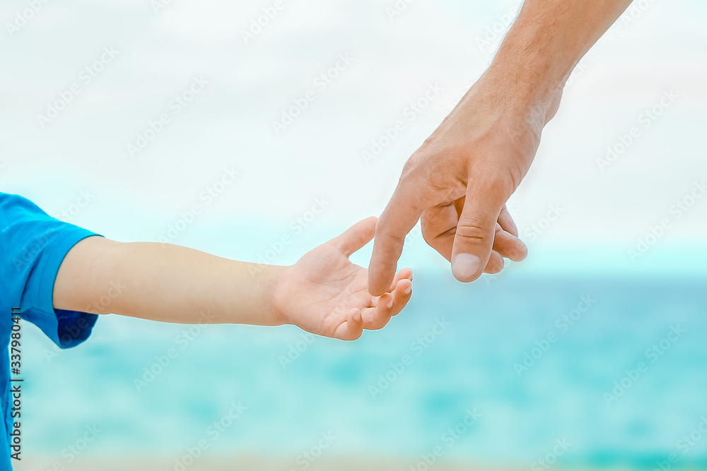beautiful hands of a happy parent and child by the sea in nature beautiful hands of a happy parent and child by the sea in nature