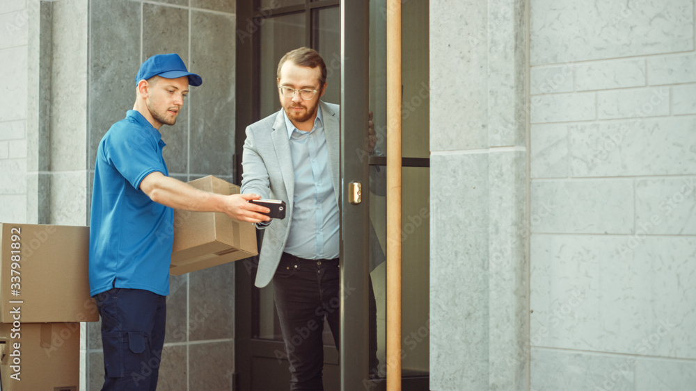 Delivery Man Takes Postal Package from a Customer who Signs Electronic Signature POD Device. Loads Delivery into His Truck / Van. In Business District Courier Takes Cardboard Box Parcel from a Man Delivery Man Takes Postal Package from a Customer who Signs Electronic Signature POD Device. Loads Delivery into His Truck / Van. In Business District Courier Takes Cardboard Box Parcel from a Man