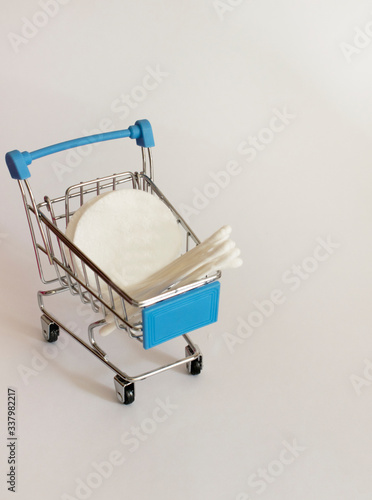 cotton pads and paper cotton buds in a basket
