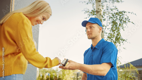 Beautiful Young Woman Meets Delivery Man who Gives Her Cardboard Box Package, She Signs Electronic Signature POD Device. Courier Delivering Parcel in the Suburban Neighborhood