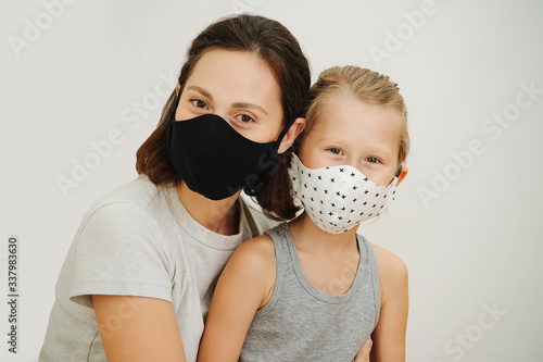 portrait of mother and son in protective masks photo