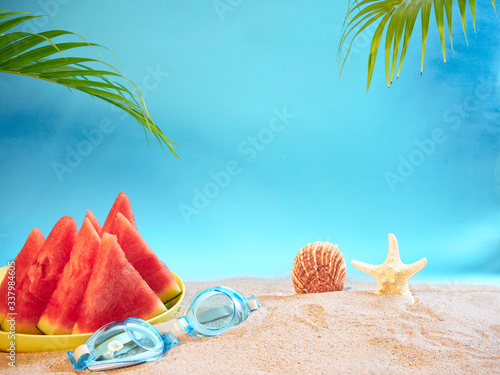 Fototapeta Naklejka Na Ścianę i Meble -  Watermelon and swimming goggles on beach.