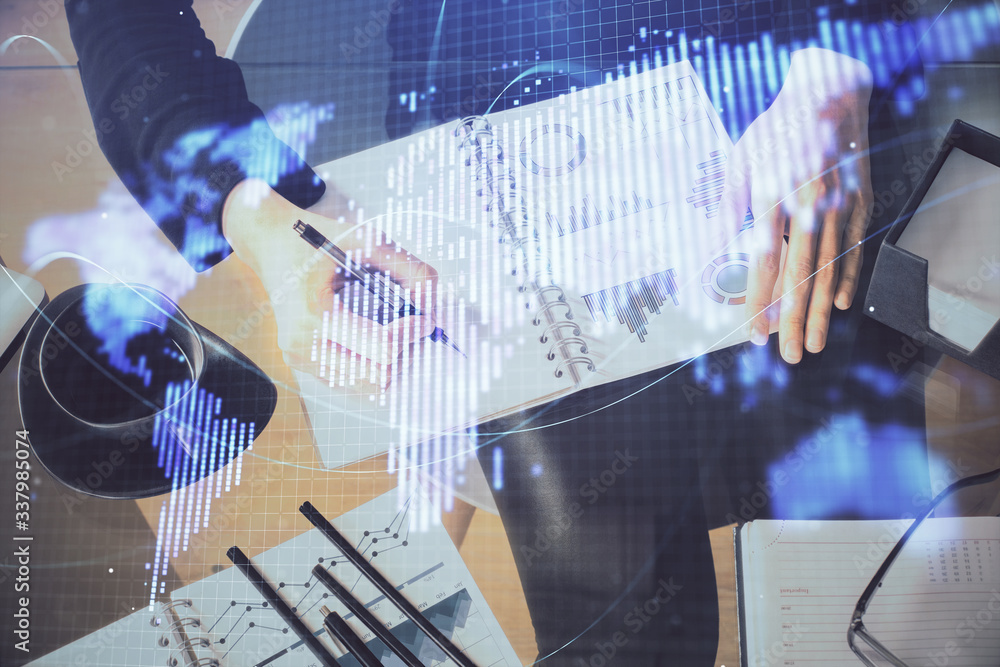 International business hologram over hands taking notes background. Concept of success. Multi exposure International business hologram over hands taking notes background. Concept of success. Multi exposure
