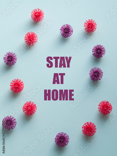 Coronavirus plastic models with inscription Stay at home. Sars-cov-2 pandemic concept COVID-19 pandemic concept 