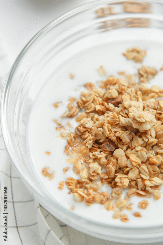 Porridge flakes in a bowl with milk. Granola for Breakfast with yogurt and walnuts. Porridge flakes in a bowl with milk. Granola for Breakfast with yogurt and walnuts.