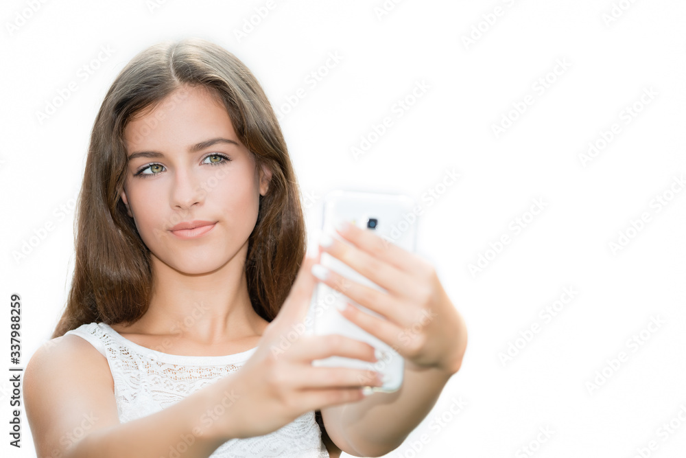 Teenage girl taking a self portrait photo, selfie on the white background.Copy space Teenage girl taking a self portrait photo, selfie on the white background.Copy space