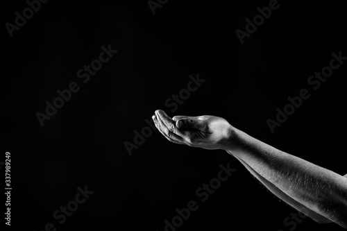 Hands Praying, palms up isolated on black background, copy space © AnnJane