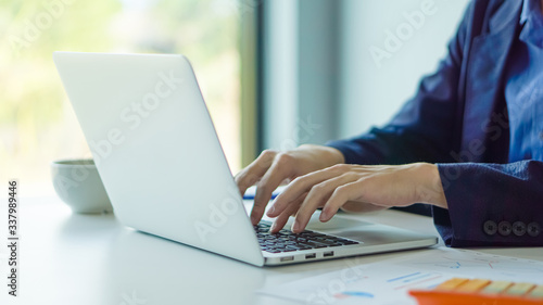 Businessman or accountant working on laptop computer with business document, business financial accounting concept.