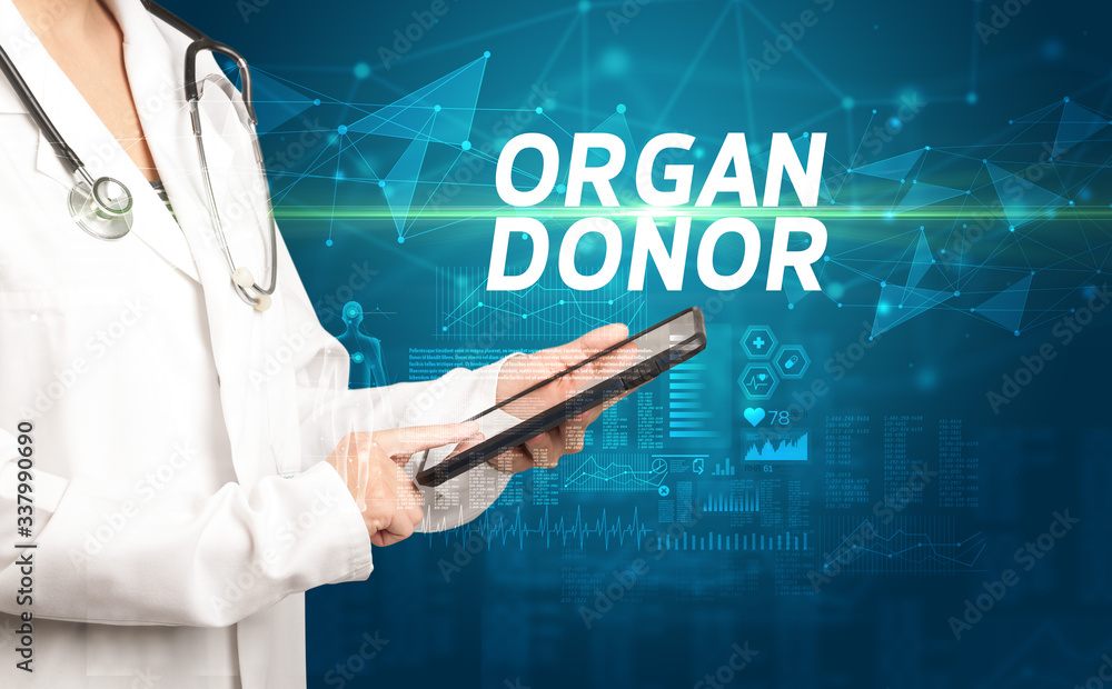 doctor writes notes on the clipboard with ORGAN DONOR inscription, medical diagnosis concept doctor writes notes on the clipboard with ORGAN DONOR inscription, medical diagnosis concept