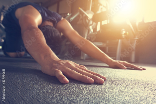 Wallpaper Mural young man in sportswear stretching before training in gym. copy space. Torontodigital.ca