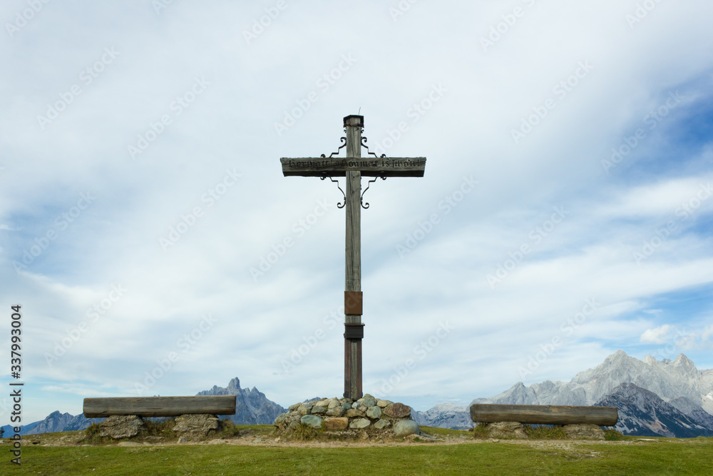 Large crucifix on mountain summit in the Austrian Alps during summer Large crucifix on mountain summit in the Austrian Alps during summer
