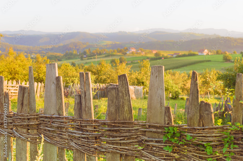 Old wooden fence in traditional style. Mountain village in western Serbia, Europe.