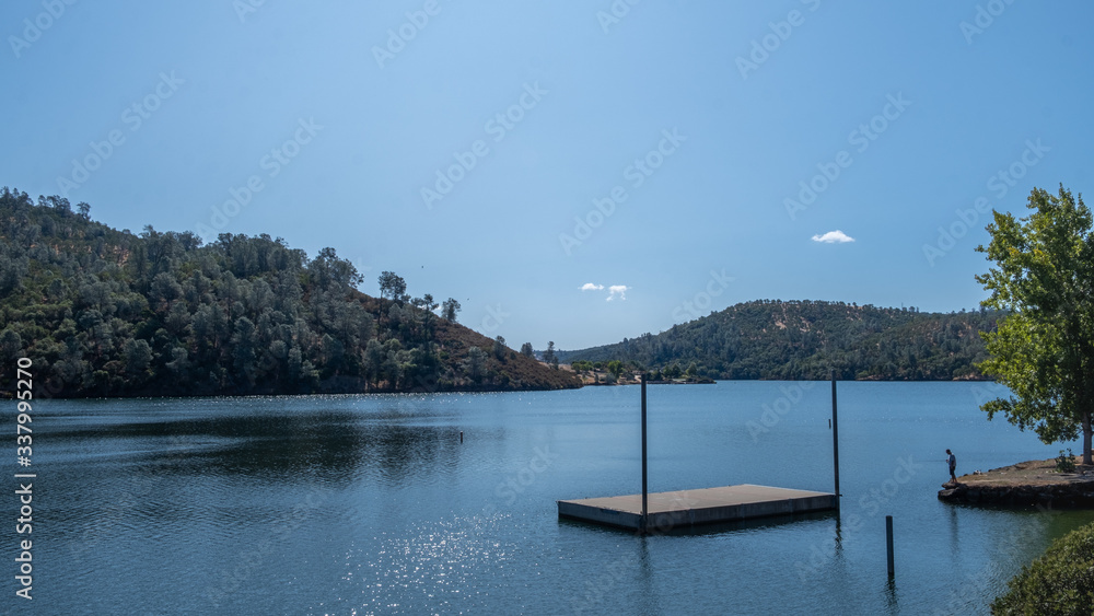 View on the lake with forest and blue sky