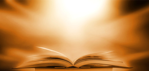 Abstract gold magic book on wooden background