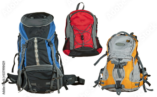 Travel backpack isolated on a white background. Multicolored shopping bags close up. Several types of backpacks. photo