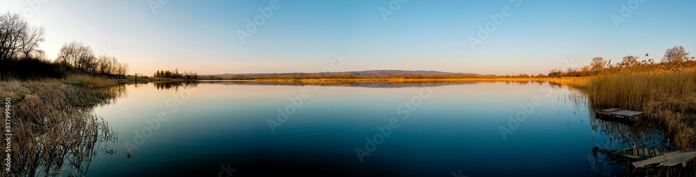 colorful panorama of autumn lake on a bright sunny day