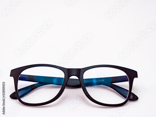 Minimalist close up shot of an eyeglass on white background for ophthalmology concept.
