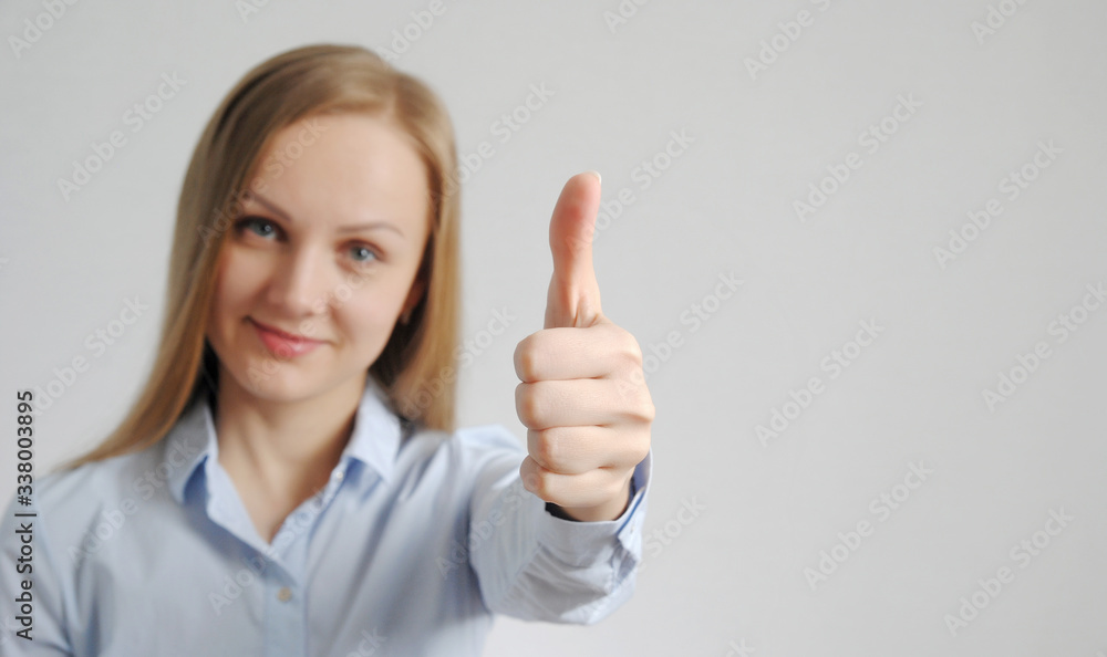 woman shows thumb up. good, positive mark and result gesture from pretty girl. well done concept woman shows thumb up. good, positive mark and result gesture from pretty girl. well done concept