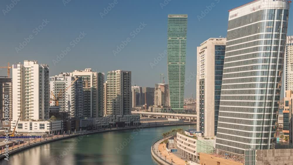 Aerial view of constructing skyscrapers timelapse with blue sky near beautiful canal and waterfront in Business Bay, Dubai, United Arab Emirates Aerial view of constructing skyscrapers timelapse with blue sky near beautiful canal and waterfront in Business Bay, Dubai, United Arab Emirates