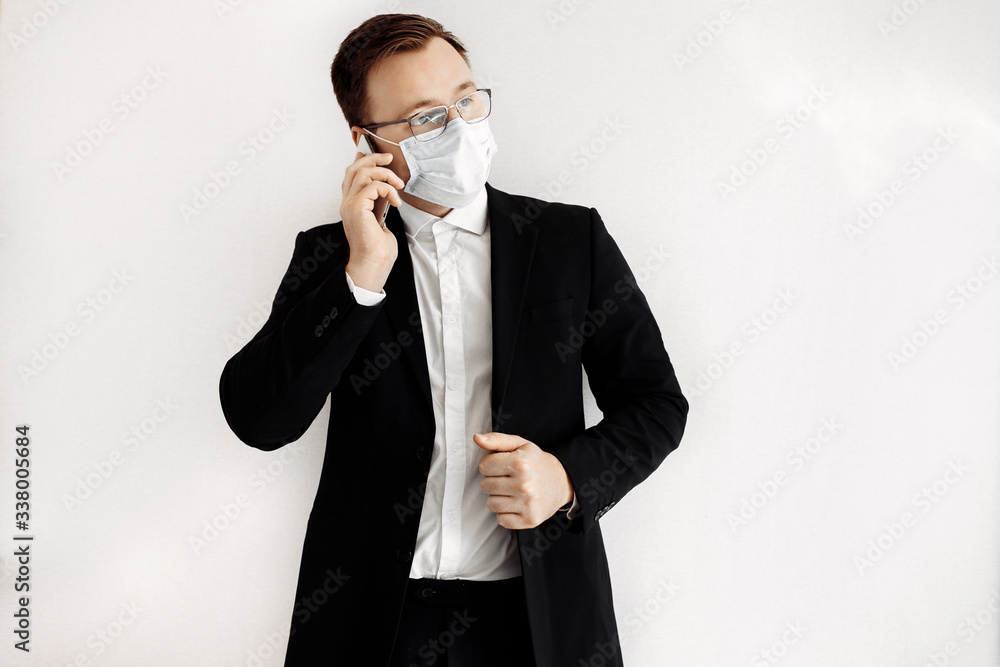 European business man working from home and using medical mask for protect . Concept,contagious disease, coronavirus.
European business man working from home and using medical mask for protect . Concept,contagious disease, coronavirus.