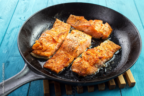 Pan seared salmon fillets on cast iron skillet