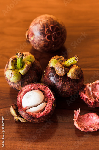 Purple mangosteen on wooden table.