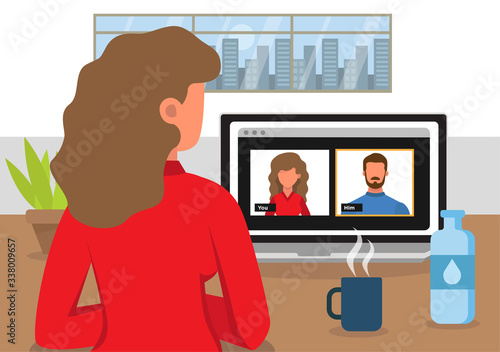 Close-up of a woman from behind communicating by video conference with a man. Virtual meeting. Video conference. Video chat.
