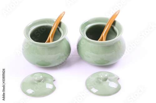 Containers of condiment ( green color) isolated background.