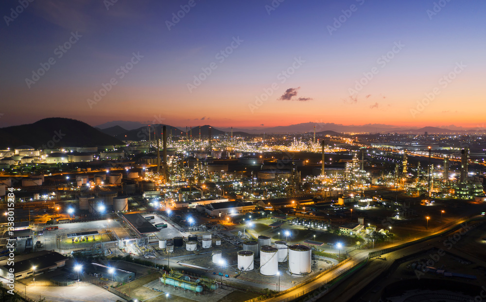 Aerial view oil storage tank with oil refinery factory industrial. Oil refinery plant at night. industry factory concept and transportation.