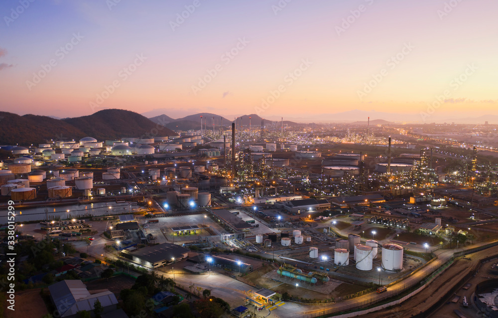 Fototapeta premium Aerial view oil storage tank with oil refinery factory industrial. Oil refinery plant at night. industry factory concept and transportation.