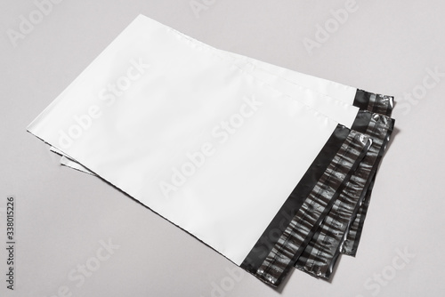 Set of white polythene envelopes on grey background photo