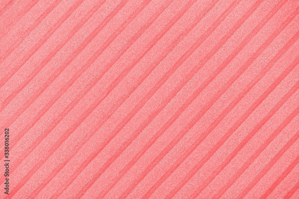 Fototapeta premium Plisse background toned in trendy color 2020 flame scarlet. geometric cloth lines. Fabric, textile close up.
