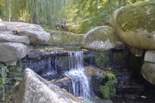 small waterfall and stones in the mountain park