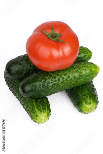 Tomato and cucumbers on a white background