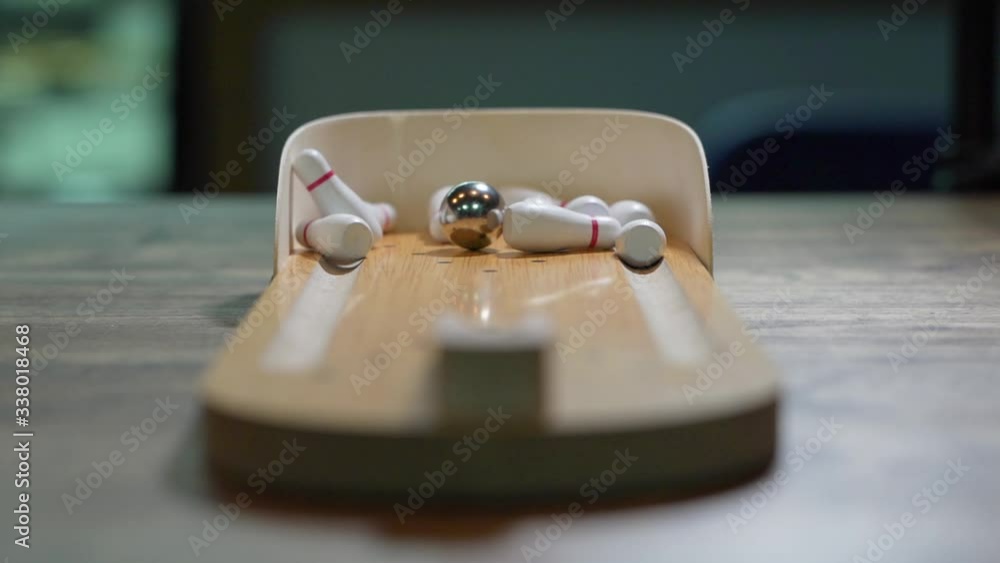 Mini bowling, board game, an iron ball rolls and knocks down all the pins, the concept of winning and hitting the target Mini bowling, board game, an iron ball rolls and knocks down all the pins, the concept of winning and hitting the target